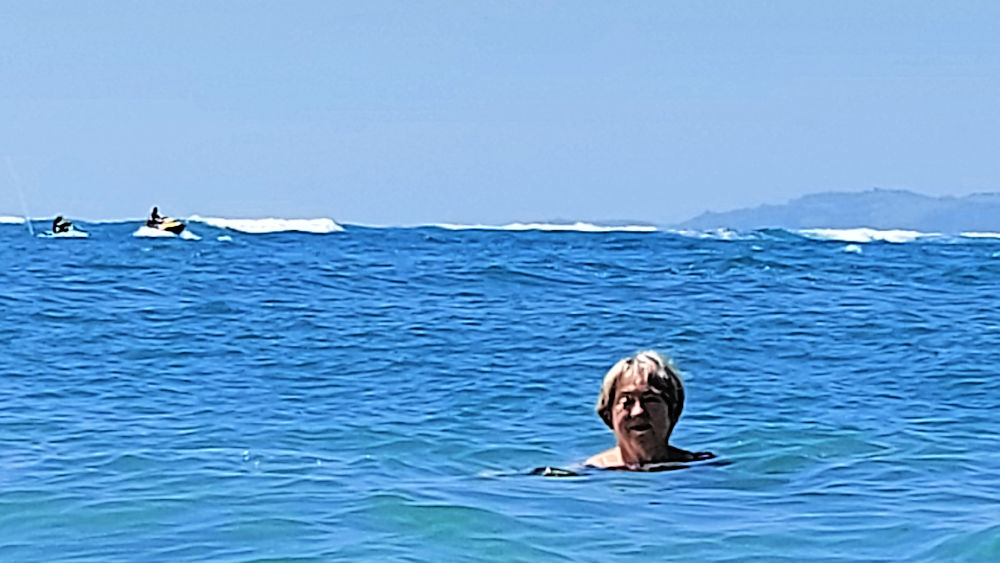 Rain up to her nick in the ocean